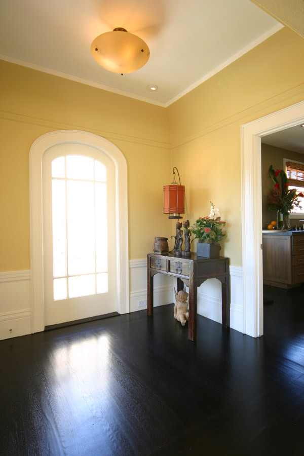 Photo of a mid-sized traditional vestibule in San Francisco with yellow walls and dark hardwood floors.