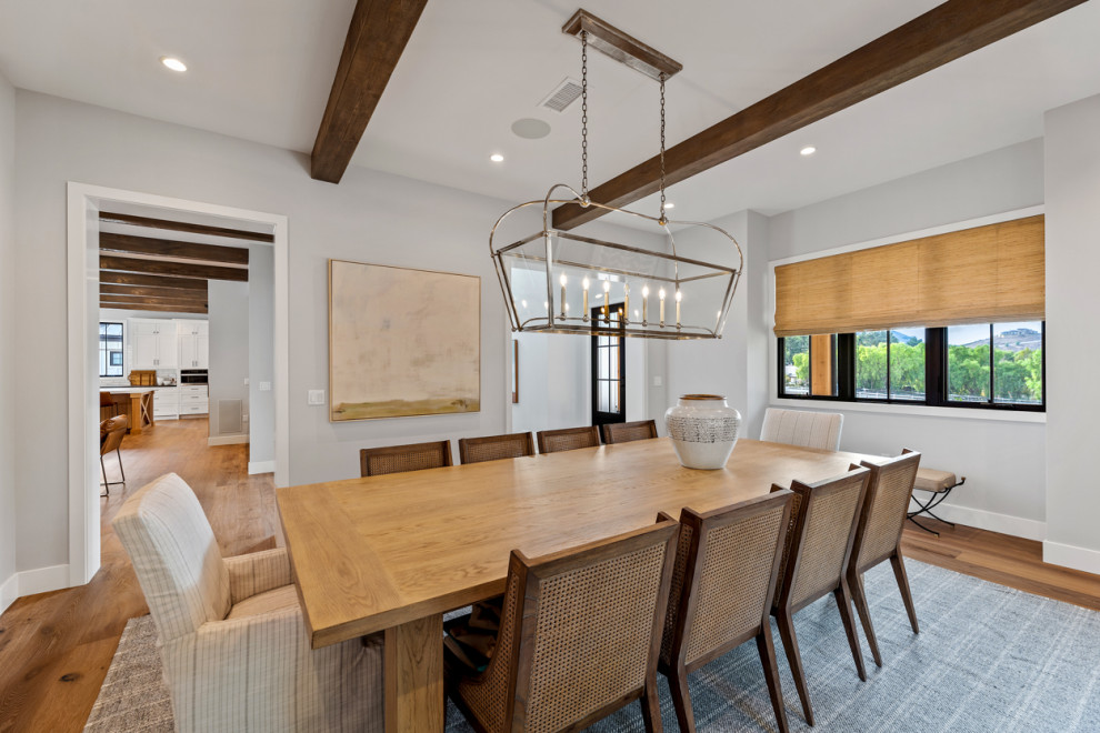 Inspiration for an expansive country separate dining room in Los Angeles with grey walls, light hardwood floors, beige floor and exposed beam.