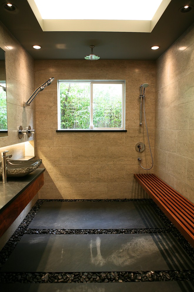 This is an example of a mid-sized contemporary 3/4 bathroom in Albuquerque with a vessel sink, flat-panel cabinets, medium wood cabinets, soapstone benchtops, an open shower, gray tile, stone tile, grey walls and limestone floors.