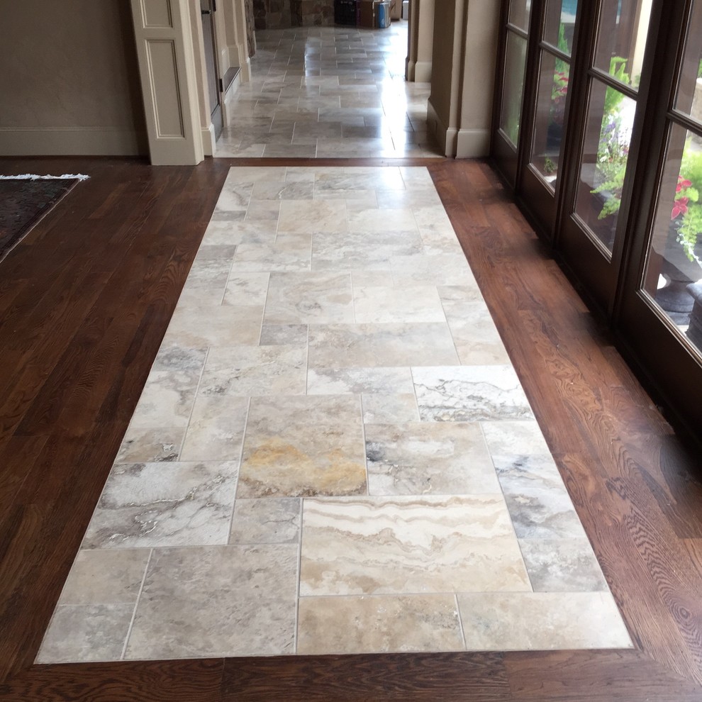 This is an example of a mid-sized mediterranean hallway in Houston with beige walls and marble floors.