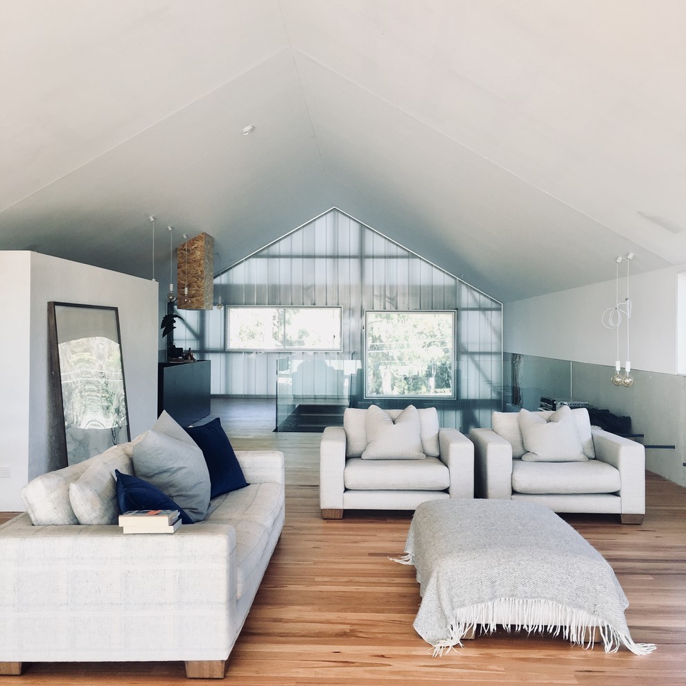This is an example of an expansive contemporary formal open concept living room in Brisbane with white walls, no fireplace, medium hardwood floors and brown floor.