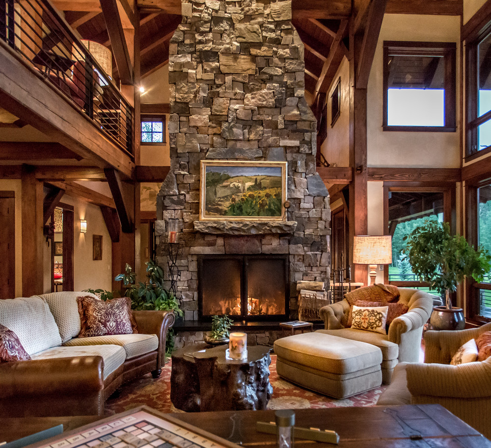 Inspiration for an expansive country living room in Denver with a wood stove and a stone fireplace surround.