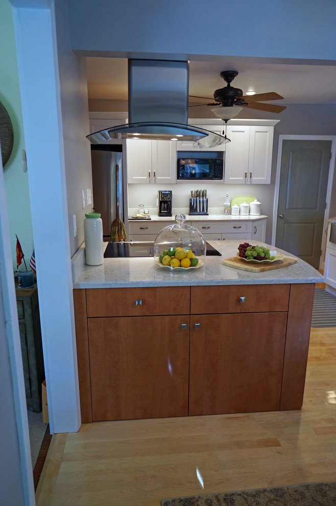 Eat-in kitchen - large transitional l-shaped light wood floor eat-in kitchen idea in Boston with a farmhouse sink, shaker cabinets, white cabinets, quartz countertops, white backsplash, stone slab backsplash, stainless steel appliances and an island