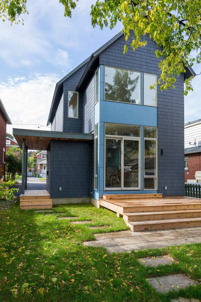 Photo of a mid-sized modern two-storey blue house exterior in Ottawa with concrete fiberboard siding, a gable roof, a shingle roof, a grey roof and shingle siding.