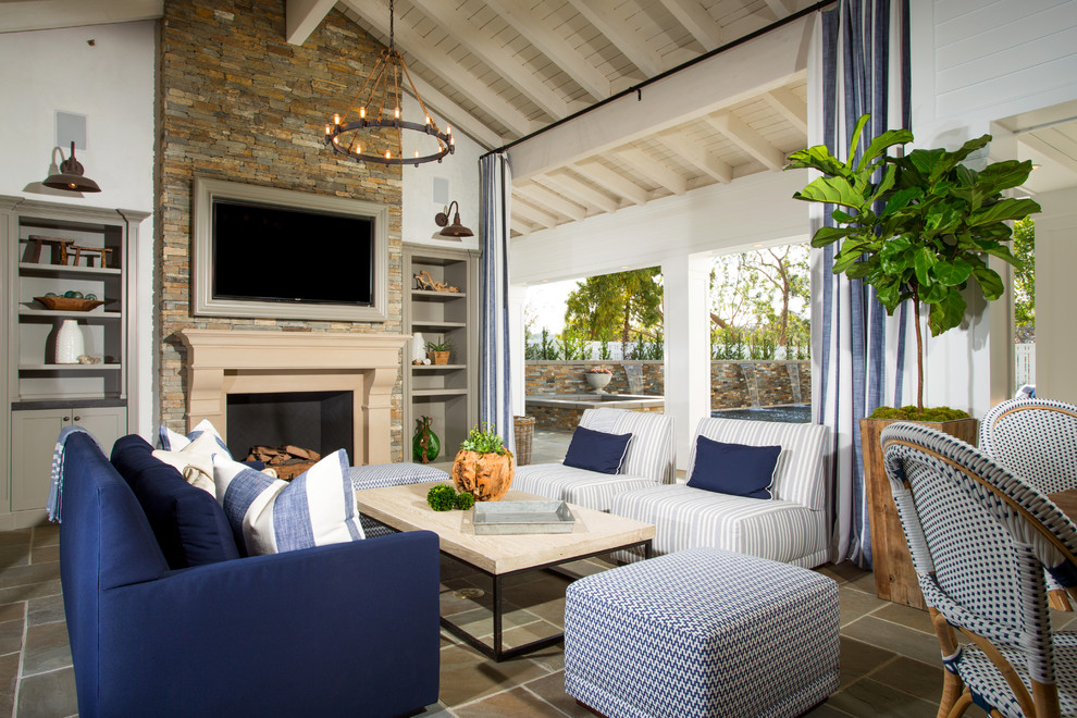 This is an example of a large traditional patio in Los Angeles with a roof extension.