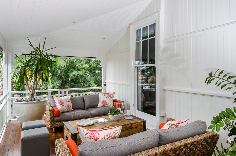 Beach style deck in Brisbane with a roof extension.