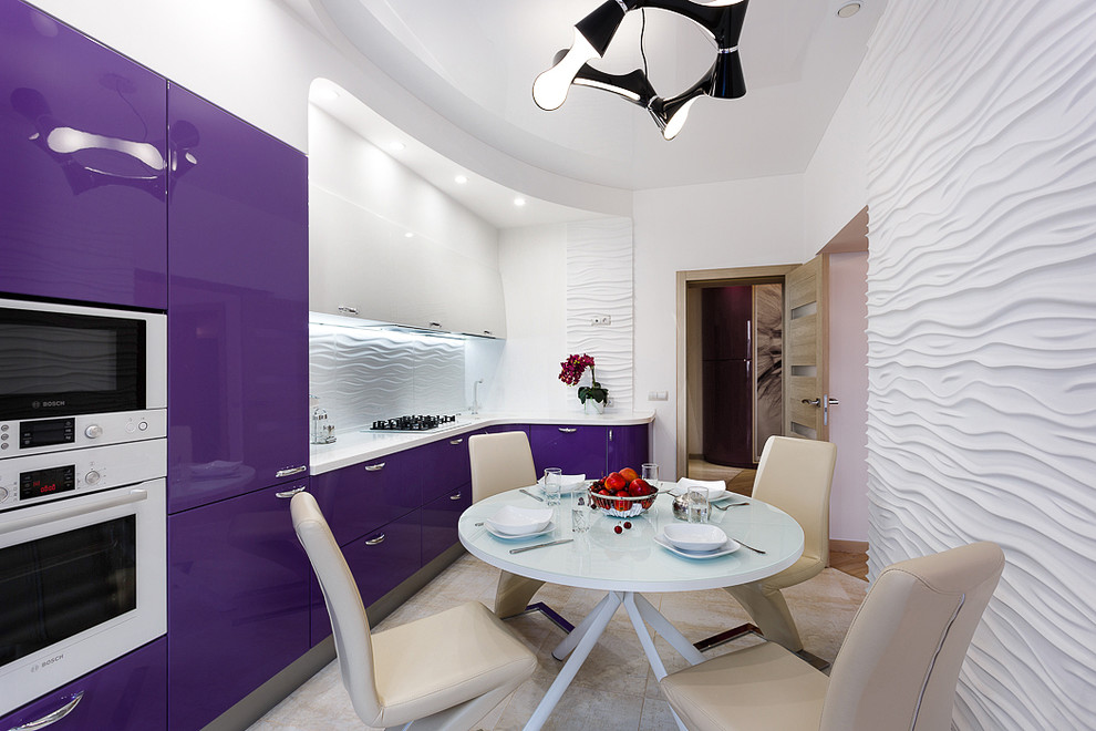 This is an example of a mid-sized contemporary l-shaped open plan kitchen in Other with an undermount sink, purple cabinets, quartz benchtops, white splashback, ceramic splashback, white appliances, porcelain floors, beige floor and white benchtop.
