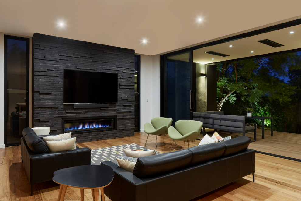 Design ideas for a mid-sized contemporary open concept living room in Adelaide with white walls, medium hardwood floors, a ribbon fireplace, a brick fireplace surround, a wall-mounted tv and brown floor.
