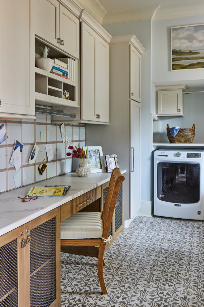 This is an example of a medium sized eclectic single-wall utility room in Other with shaker cabinets, brown cabinets, marble worktops, blue splashback, blue walls, ceramic flooring, a side by side washer and dryer, grey floors and white worktops.