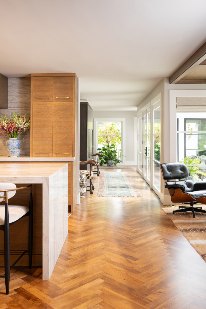 Example of a large classic medium tone wood floor and brown floor hallway design in Other