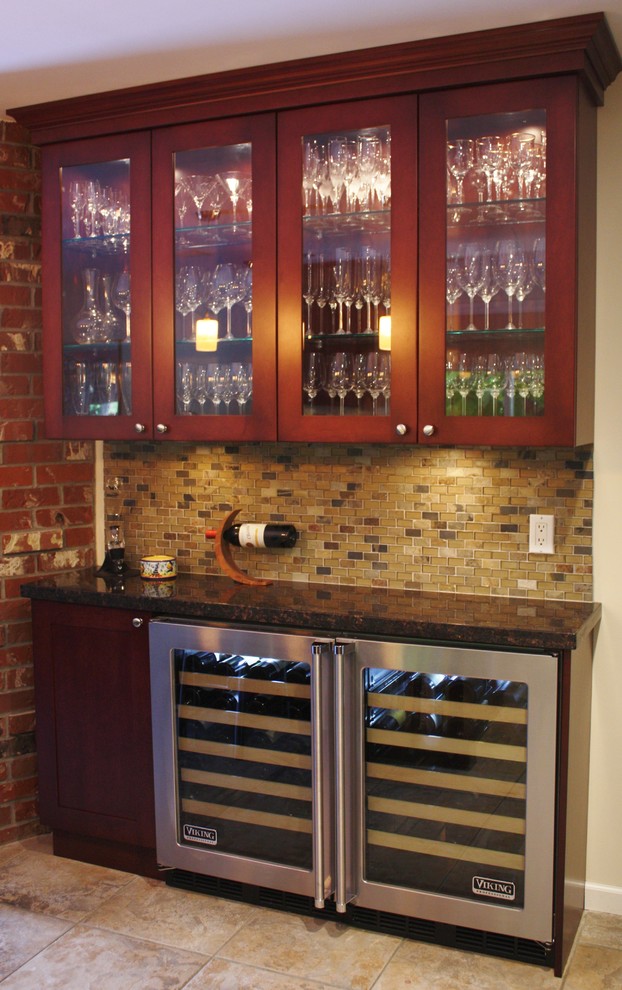 Inspiration for a transitional single-wall home bar in Vancouver with glass-front cabinets, medium wood cabinets, granite benchtops and multi-coloured splashback.