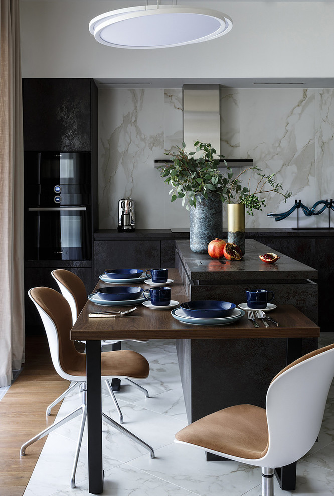 Design ideas for a contemporary eat-in kitchen in Moscow with flat-panel cabinets, black cabinets, white splashback, stone slab splashback, black appliances, marble floors, with island, white floor and black benchtop.