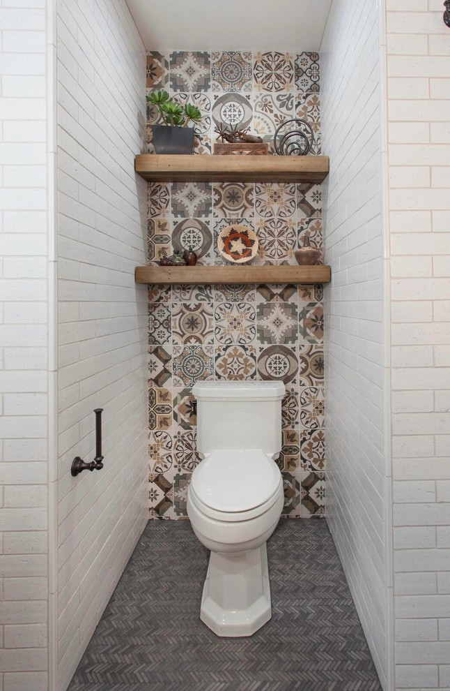 Mediterranean powder room in San Diego with shaker cabinets, medium wood cabinets, a one-piece toilet, white tile, subway tile, white walls, mosaic tile floors, a drop-in sink, grey floor and grey benchtops.