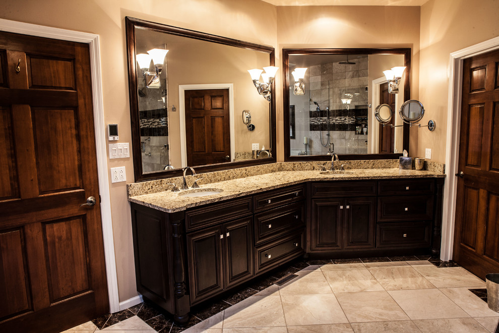Photo of a mid-sized traditional 3/4 bathroom in Wichita with raised-panel cabinets, dark wood cabinets, beige walls, ceramic floors, an undermount sink, granite benchtops and beige floor.
