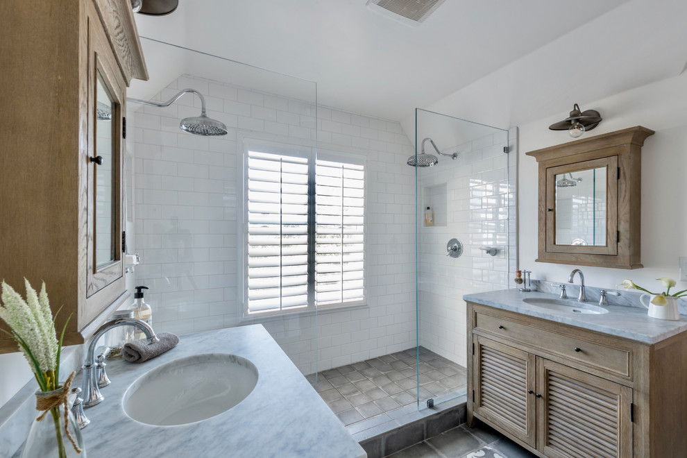 Country master bathroom in San Francisco with louvered cabinets, medium wood cabinets, a double shower, white tile, subway tile, white walls, an undermount sink, grey floor, an open shower and grey benchtops.