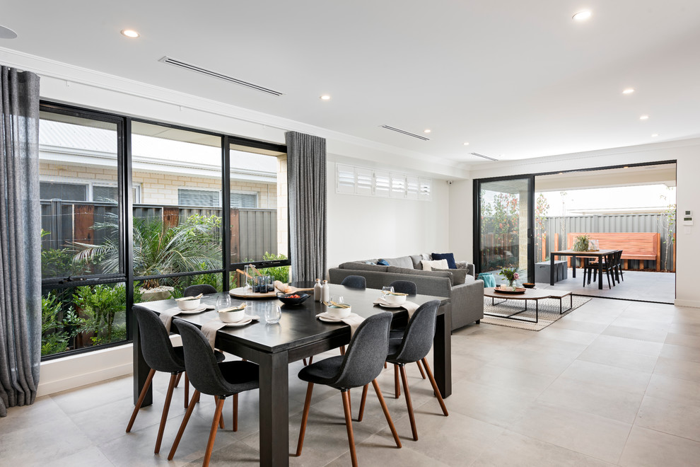 This is an example of a contemporary open plan dining in Perth with ceramic floors and white walls.
