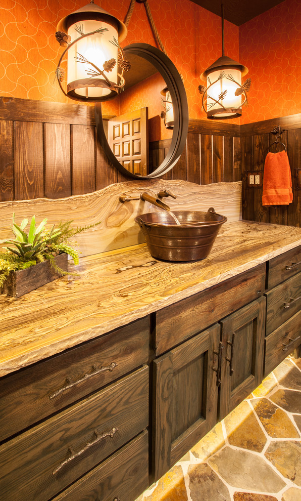Drop-in bathtub - mid-sized rustic drop-in bathtub idea with furniture-like cabinets, green cabinets, a two-piece toilet, orange walls, a vessel sink and quartzite countertops