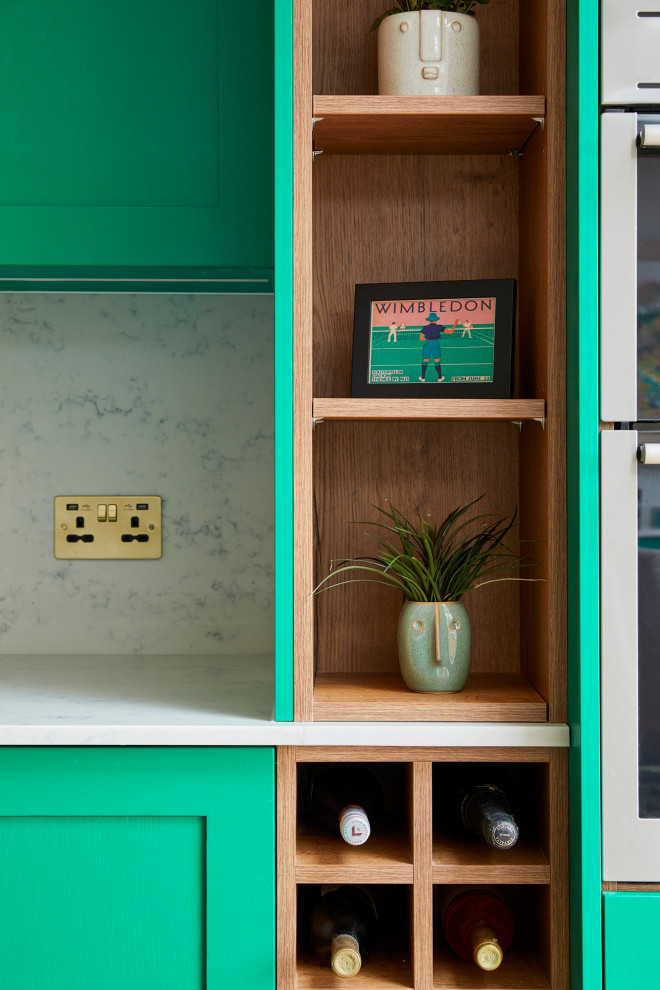 Küche mit Schrankfronten im Shaker-Stil, grünen Schränken, Marmor-Arbeitsplatte, Kücheninsel, braunem Boden und weißer Arbeitsplatte in London