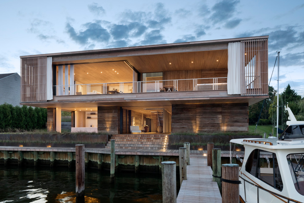 Inspiration for a contemporary two-storey brown house exterior in Baltimore with wood siding and a flat roof.