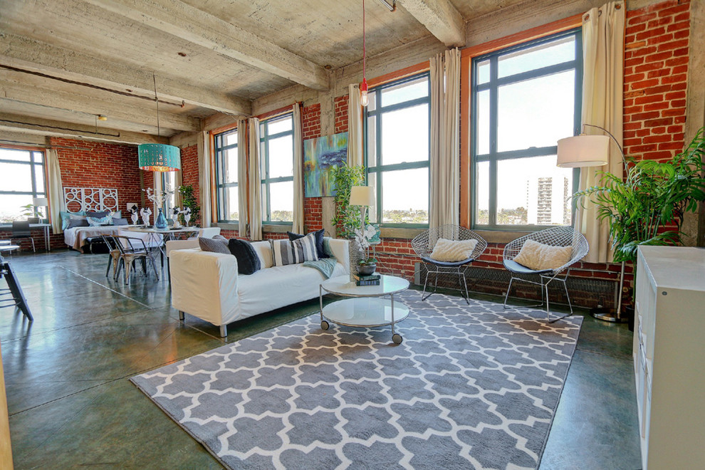 Inspiration for a large industrial open concept living room in Los Angeles with red walls and concrete floors.