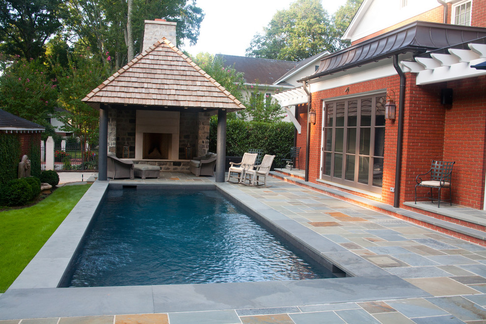 This is an example of a mid-sized transitional backyard rectangular lap pool in Charlotte with decomposed granite.