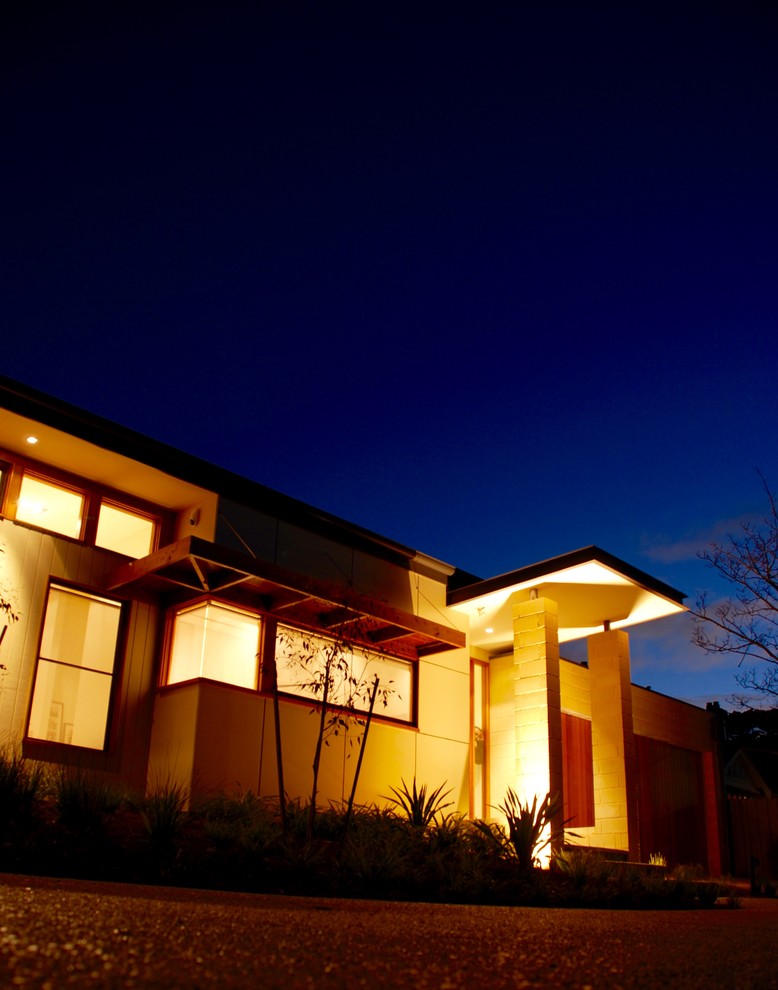 Large contemporary one-storey house exterior in Melbourne with mixed siding and a flat roof.
