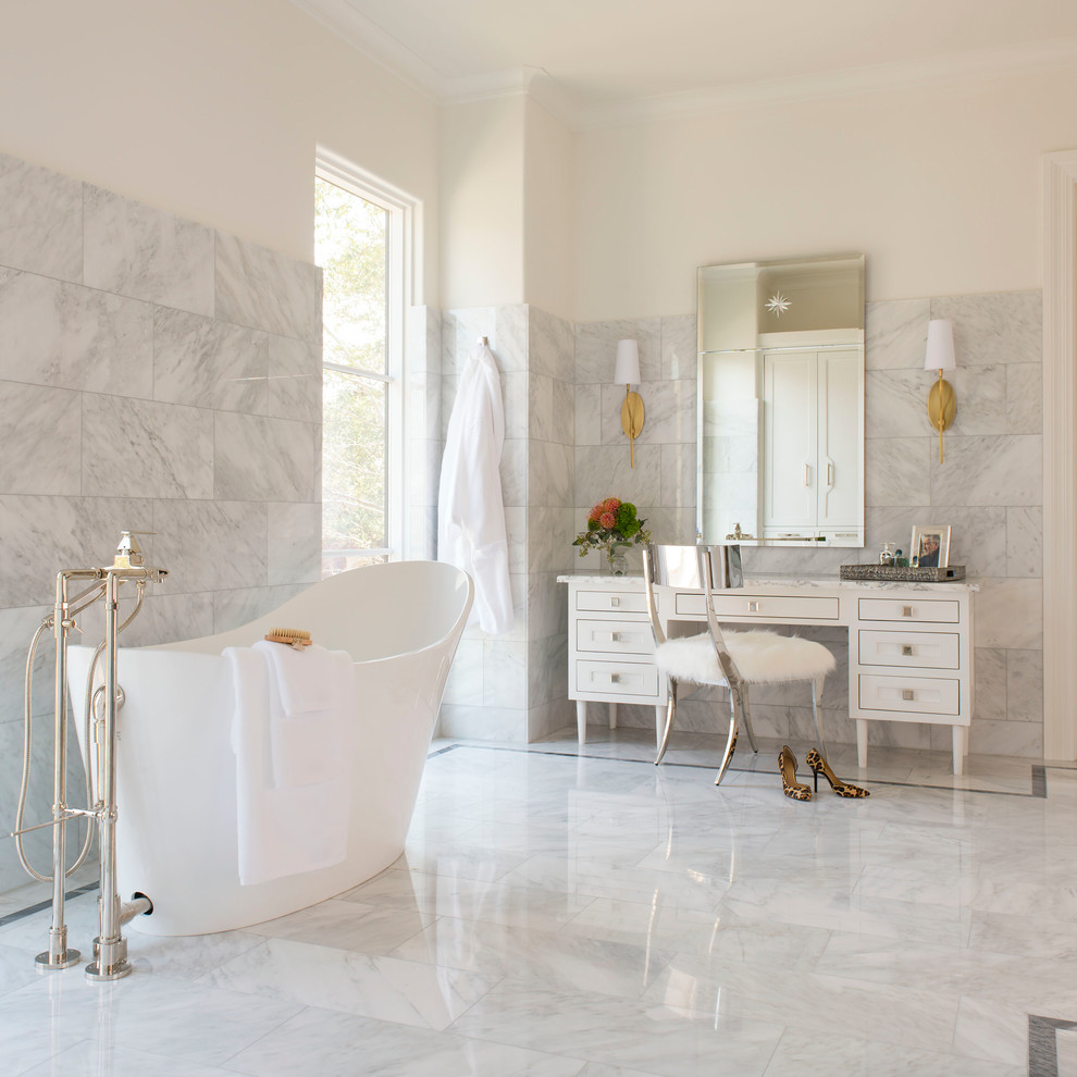 Design ideas for a mid-sized mediterranean master bathroom in Dallas with white cabinets, white walls, marble floors, marble benchtops, white floor, a freestanding tub, gray tile and shaker cabinets.