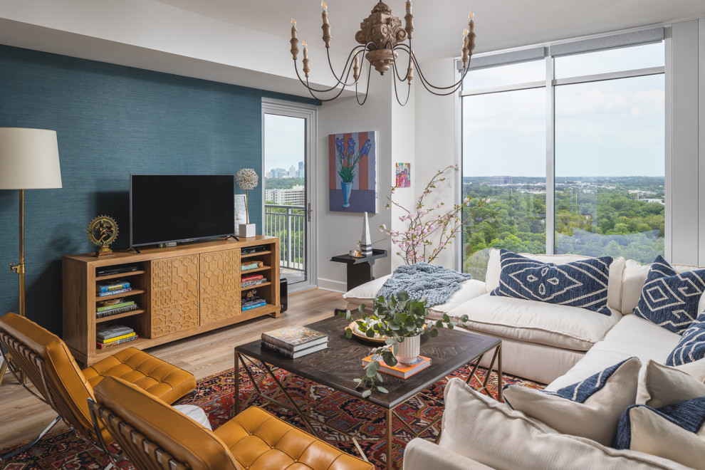 Cette image montre une salle de séjour design de taille moyenne et fermée avec un mur multicolore, parquet clair, aucune cheminée et un téléviseur indépendant.