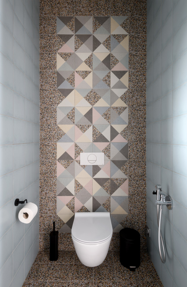 Small trendy multicolored tile and ceramic tile ceramic tile and multicolored floor powder room photo in Novosibirsk with flat-panel cabinets, medium tone wood cabinets, a wall-mount toilet, an integrated sink, glass countertops, gray countertops and a floating vanity