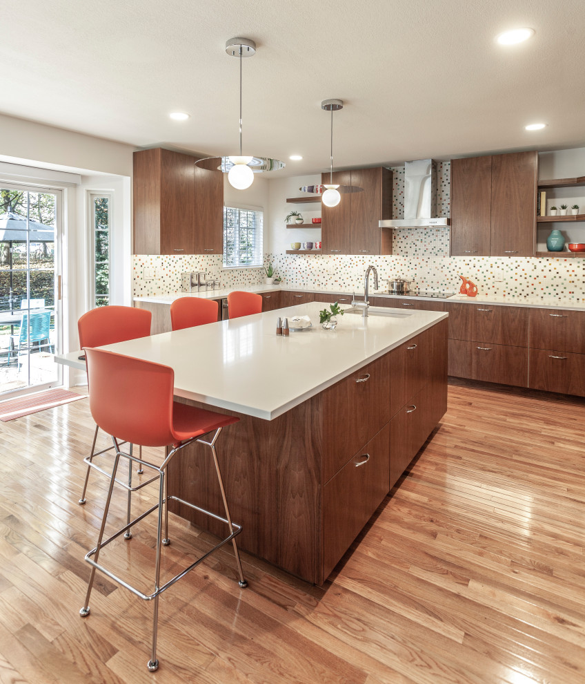 Inspiration for a large midcentury u-shaped eat-in kitchen in Detroit with an undermount sink, flat-panel cabinets, dark wood cabinets, quartz benchtops, multi-coloured splashback, ceramic splashback, stainless steel appliances, light hardwood floors, with island, brown floor and white benchtop.