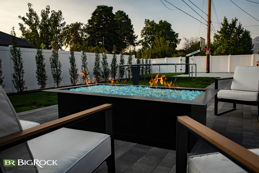 This is an example of a mid-sized transitional front yard outdoor sport court in Salt Lake City with a fire feature and brick pavers.