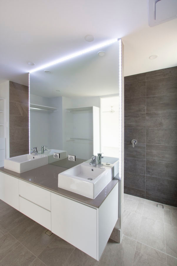 Mid-sized contemporary master bathroom in Brisbane with a double shower, a one-piece toilet, gray tile, porcelain tile, white walls and a trough sink.