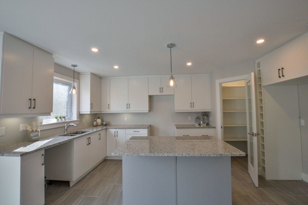 Eat-in kitchen - mid-sized transitional ceramic tile and gray floor eat-in kitchen idea with an undermount sink, flat-panel cabinets, white cabinets, granite countertops, an island and gray countertops