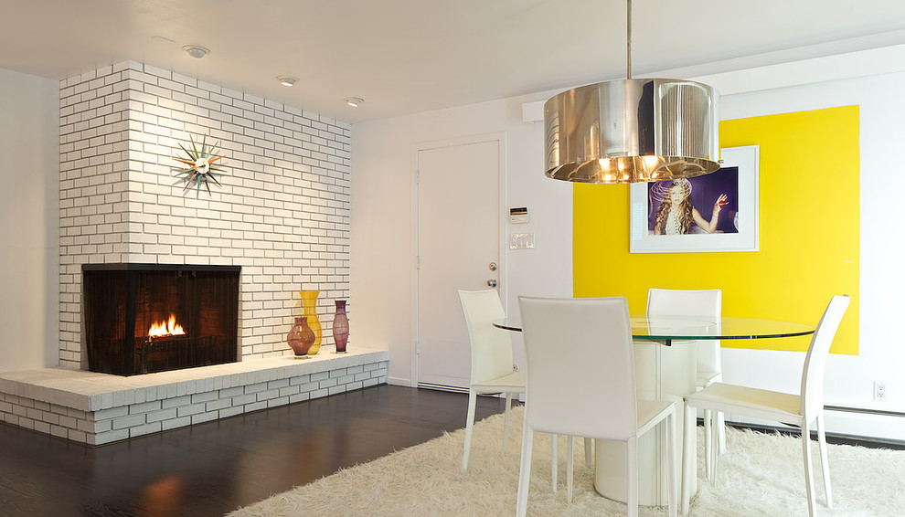 Design ideas for an eclectic dining room in Denver with a corner fireplace.