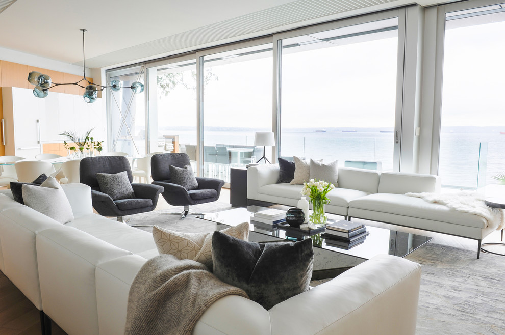 Large modern formal open concept living room in Vancouver with light hardwood floors.
