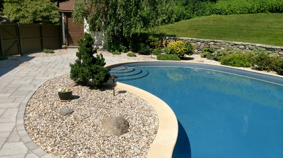 This is an example of a mid-sized full sun backyard concrete paver landscaping.