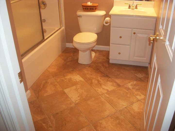 Inspiration for a transitional beige tile alcove bathtub remodel with an integrated sink, white cabinets, granite countertops and beige walls