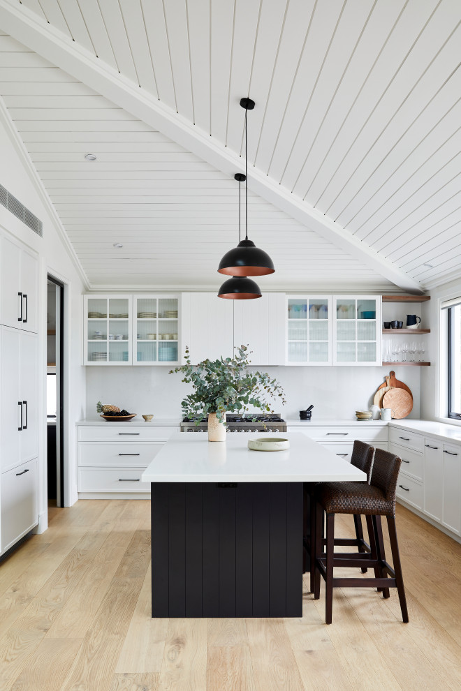 Inspiration for a large country u-shaped open plan kitchen in Sydney with an undermount sink, shaker cabinets, white cabinets, marble benchtops, white splashback, marble splashback, panelled appliances, light hardwood floors, with island, brown floor, white benchtop and vaulted.