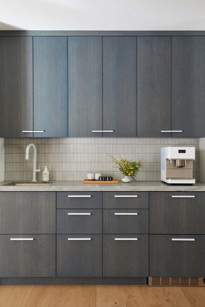 Inspiration for a small contemporary single-wall light wood floor and brown floor wet bar remodel in San Francisco with an undermount sink, flat-panel cabinets, dark wood cabinets, quartzite countertops, white backsplash, mosaic tile backsplash and gray countertops