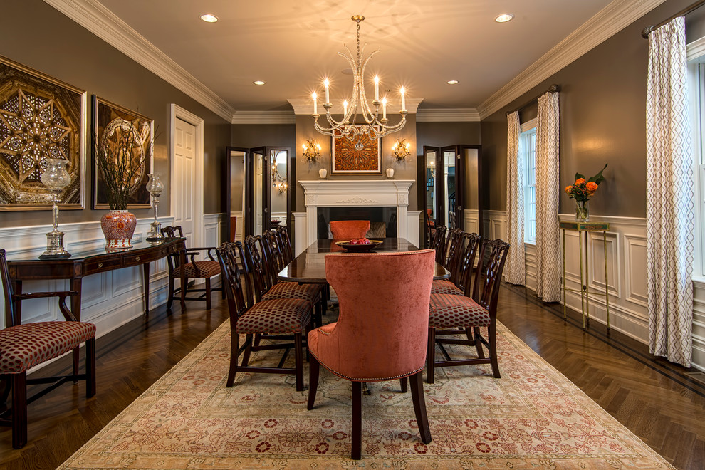Inspiration for a traditional dining room in New York with grey walls, medium hardwood floors and a standard fireplace.