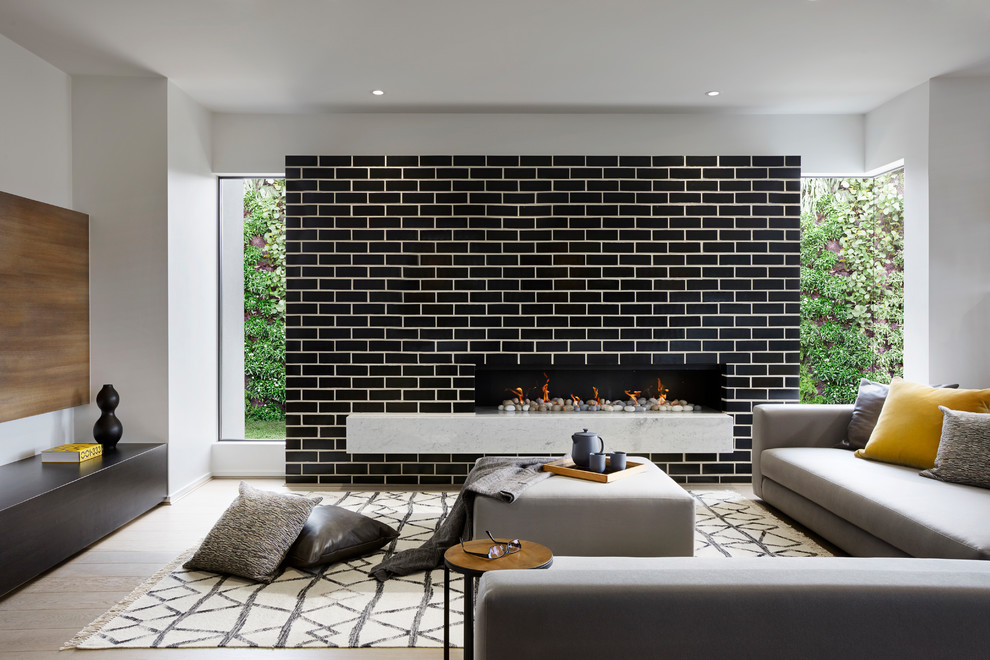 Inspiration for a contemporary living room in Melbourne with white walls, light hardwood floors, a ribbon fireplace, a brick fireplace surround and beige floor.