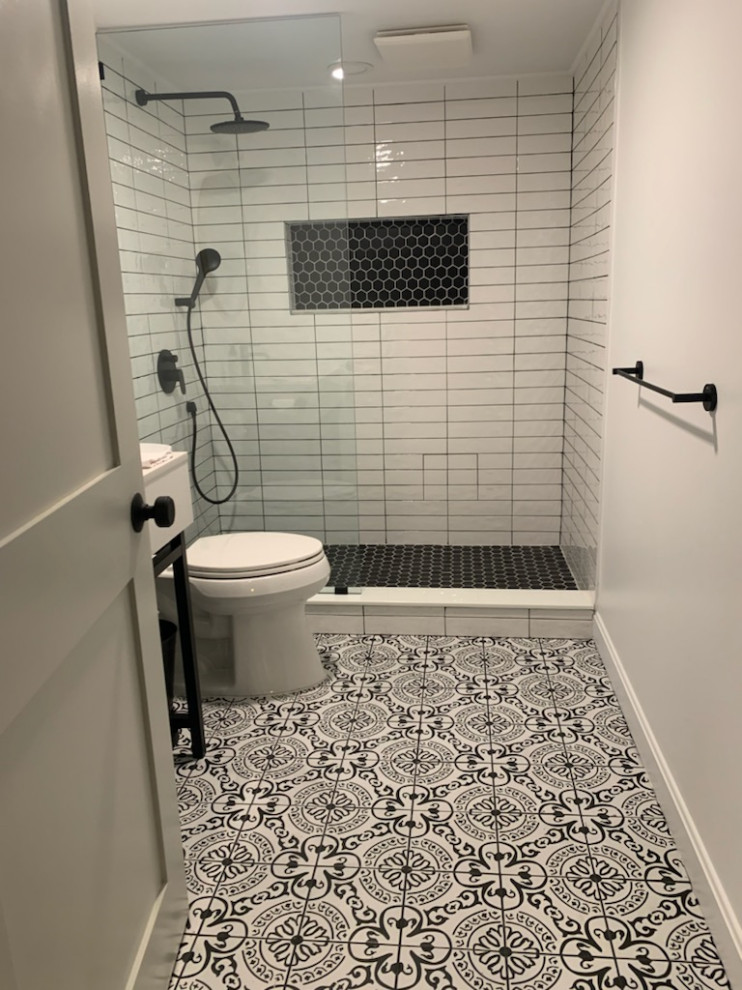 Example of a mid-sized urban 3/4 black and white tile and porcelain tile porcelain tile and single-sink bathroom design in Providence with open cabinets, white cabinets, a two-piece toilet, white walls, an undermount sink, white countertops, a niche and a freestanding vanity