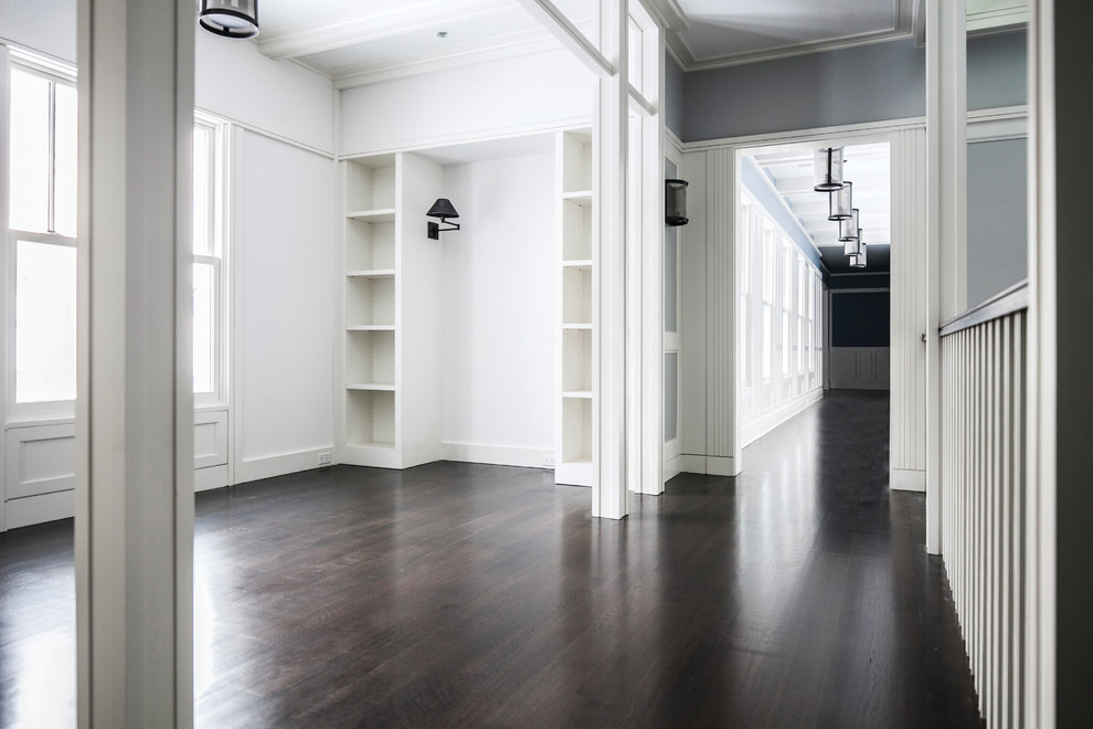 Photo of an expansive country gender-neutral dressing room in New York with dark hardwood floors.