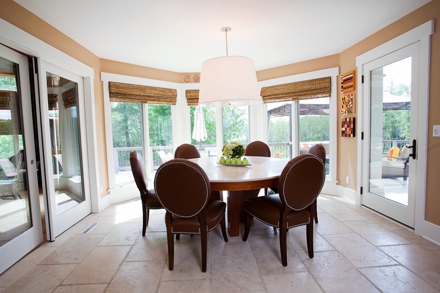 Expansive transitional kitchen/dining combo in Detroit with limestone floors.