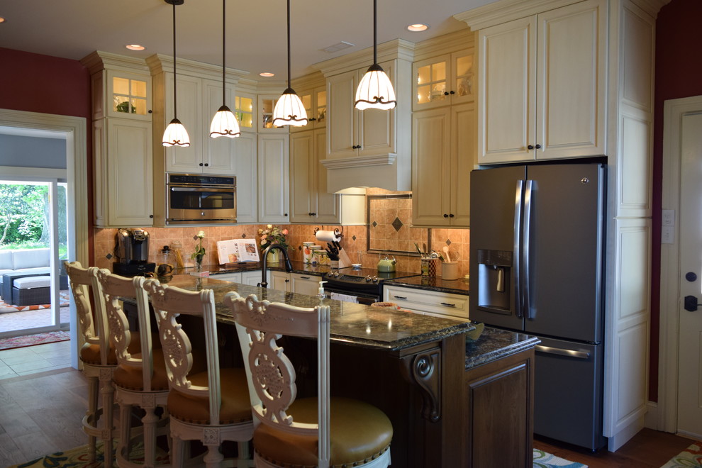 Example of a transitional medium tone wood floor kitchen design with a double-bowl sink, raised-panel cabinets, white cabinets, quartz countertops, beige backsplash, ceramic backsplash, stainless steel appliances and an island