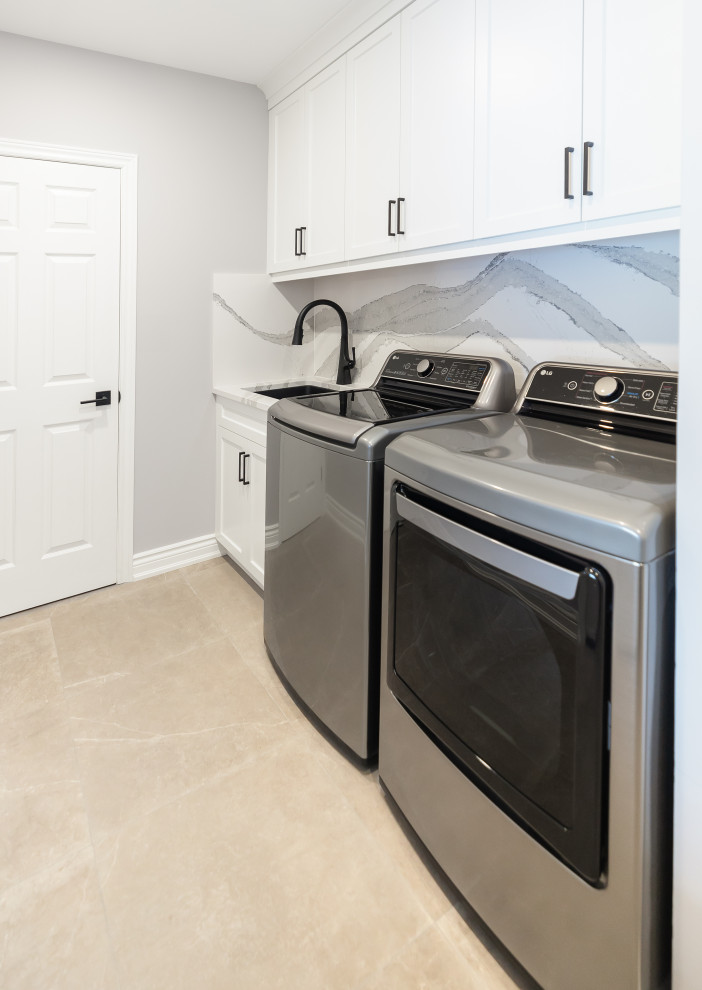 Mid-sized transitional light wood floor kitchen photo in Toronto with an undermount sink, shaker cabinets, white cabinets, quartz countertops, white backsplash, quartz backsplash, stainless steel appliances and white countertops