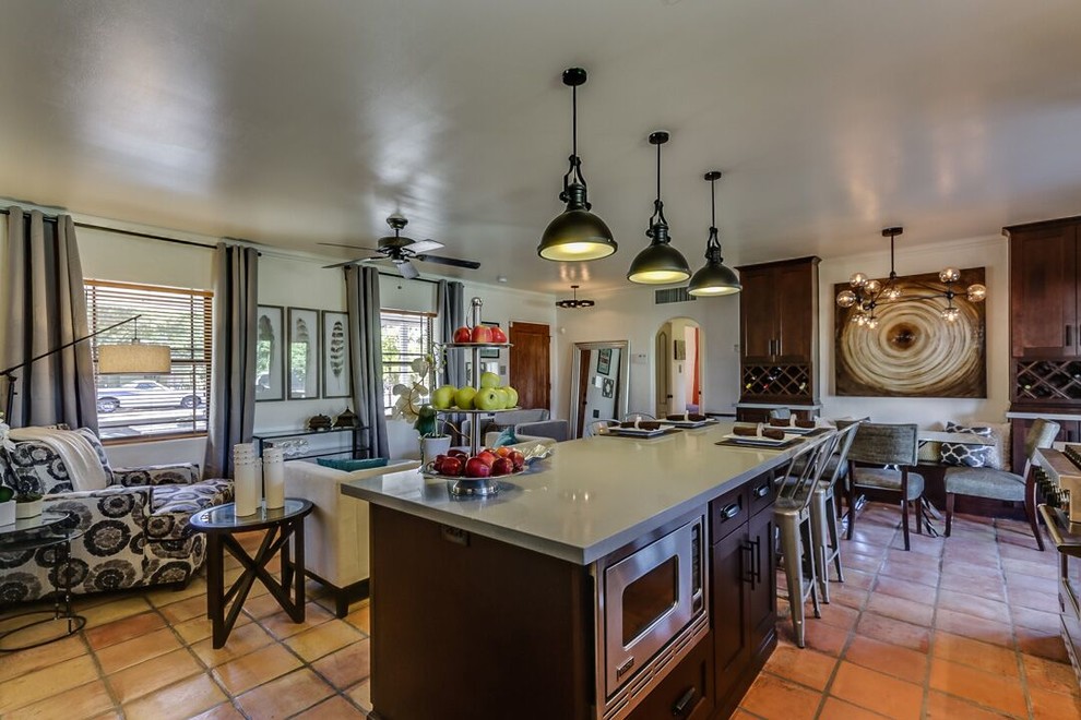 Open concept kitchen - large transitional galley terra-cotta tile and brown floor open concept kitchen idea in Phoenix with an undermount sink, shaker cabinets, dark wood cabinets, quartz countertops, stainless steel appliances and an island