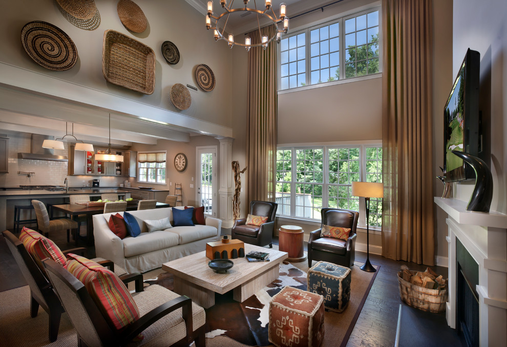 Inspiration for a large traditional open concept living room in Charlotte with beige walls, dark hardwood floors, a standard fireplace, a wood fireplace surround and a wall-mounted tv.