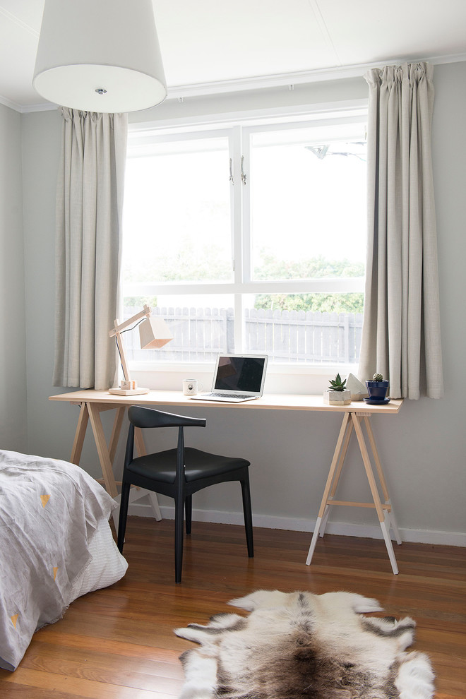 Contemporary bedroom in Auckland with grey walls, dark hardwood floors and brown floor.