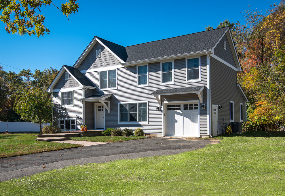 Inspiration for a mid-sized transitional gray two-story vinyl gable roof remodel in New York with a shingle roof
